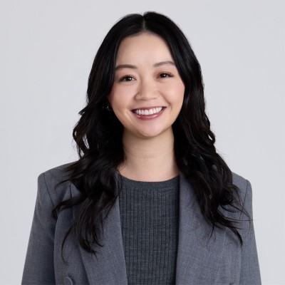 Jessica Siu_Photo Smiling Asian woman in a grey blazer at the AFP Treasury Conference, Las Vegas.