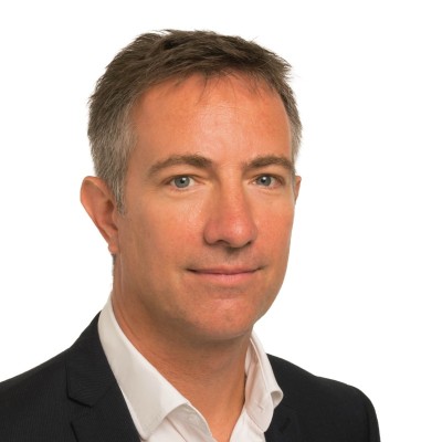 Stuart Case_Photo Headshot of a professional man in a suit and white shirt.