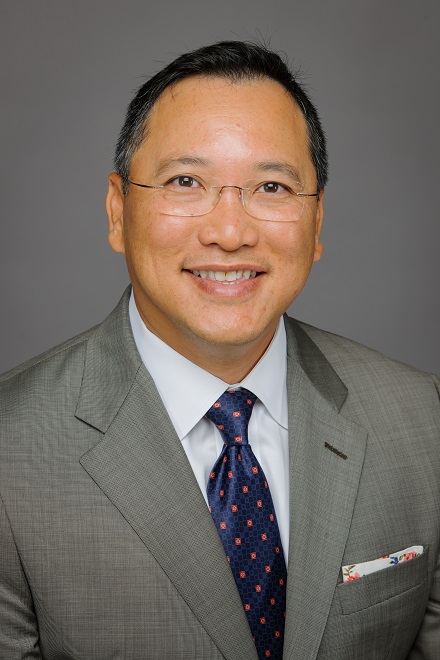 Tony Vu_Photo Portrait of a man in a gray suit, white shirt, and blue tie