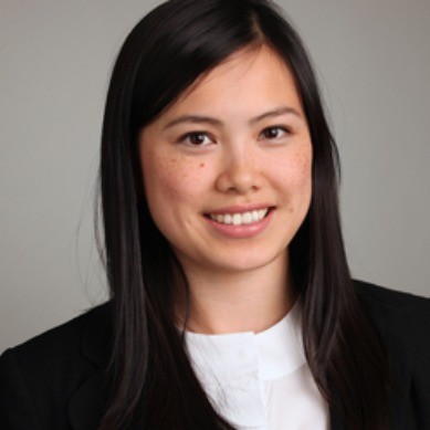Asian woman in business attire smiling, likely a Treasury Leader in London