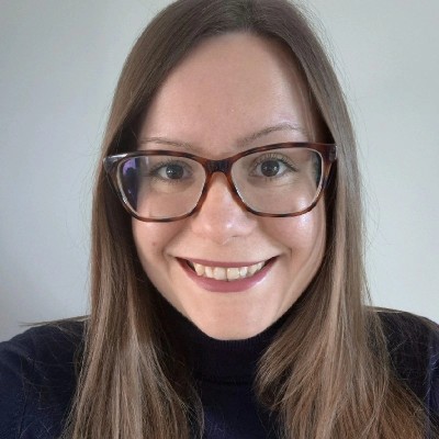 Woman with glasses smiles, discussing future skills at ACT Annual Conference 2026